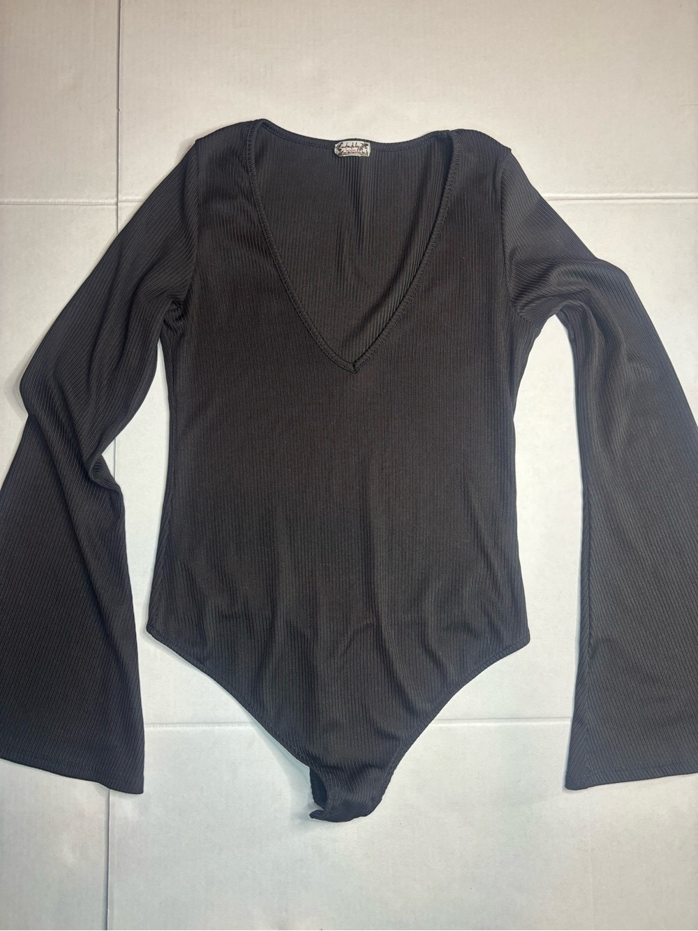 Intimately Free People black bodysuit with long bell sleeves and a V-neckline